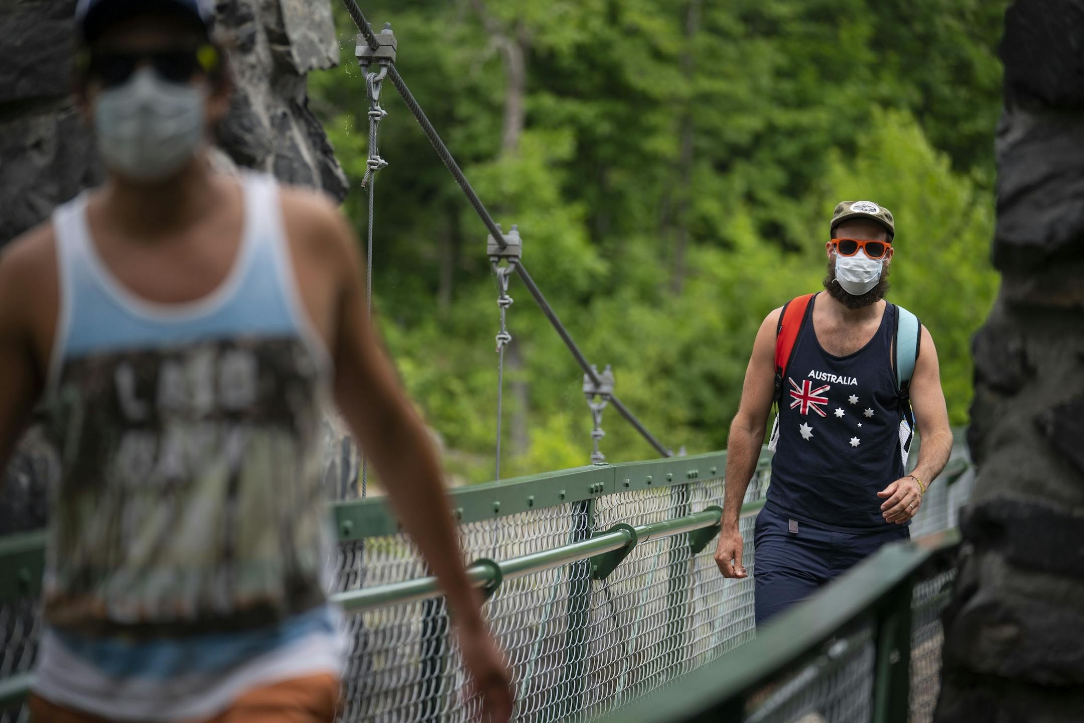 David Turley, left, and his husband, Peter Thiede, crossed the swinging bridge in Jay Cooke State Park on Wednesday. The couple was visiting Peter's parents from New York.