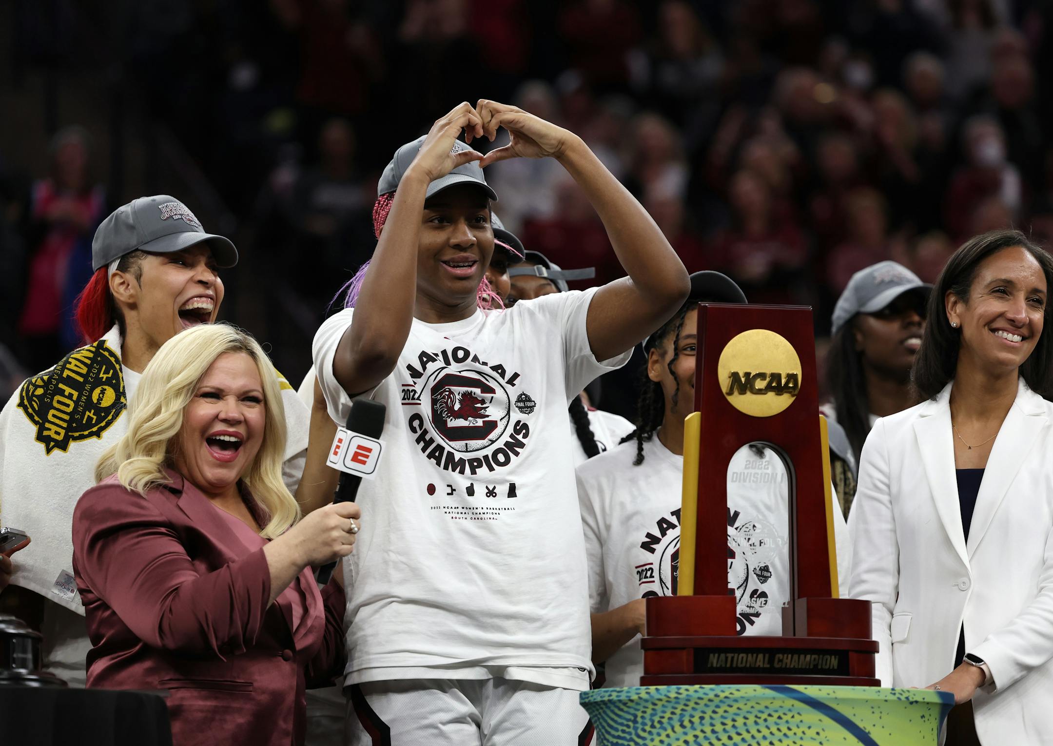 South Carolina forward Aliyah Boston (4) reacts towards former player Candace Parker.