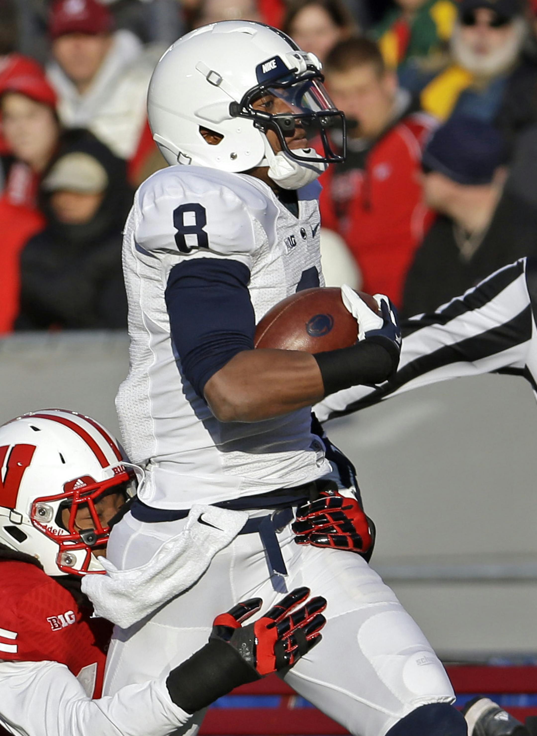 Wisconsin's Dezmen Southward (12) tackles Penn State's Allen Robinson (8) after a 52-yard pass reception during the first half of an NCAA college football game on Saturday, Nov. 30, 2013, in Madison, Wis. (AP Photo/Morry Gash)