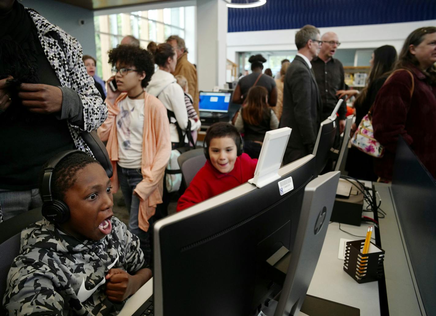 Zachariah Seals,10, far left, gets a kick out of the new computers and started playing some games he found on the internet. "This is stupid crazy," about being able to access his favorite games.] North Minneapolis gets a brand new, $10.5 million library Thursday when the Webber Park branch opens. The old libary serving the Camden neighborhood was torn down in 2014. The new one, designed by Minneapolis-based architect Mohammad Lawal, is part of the Hennepin County system, which now has 41 locatio