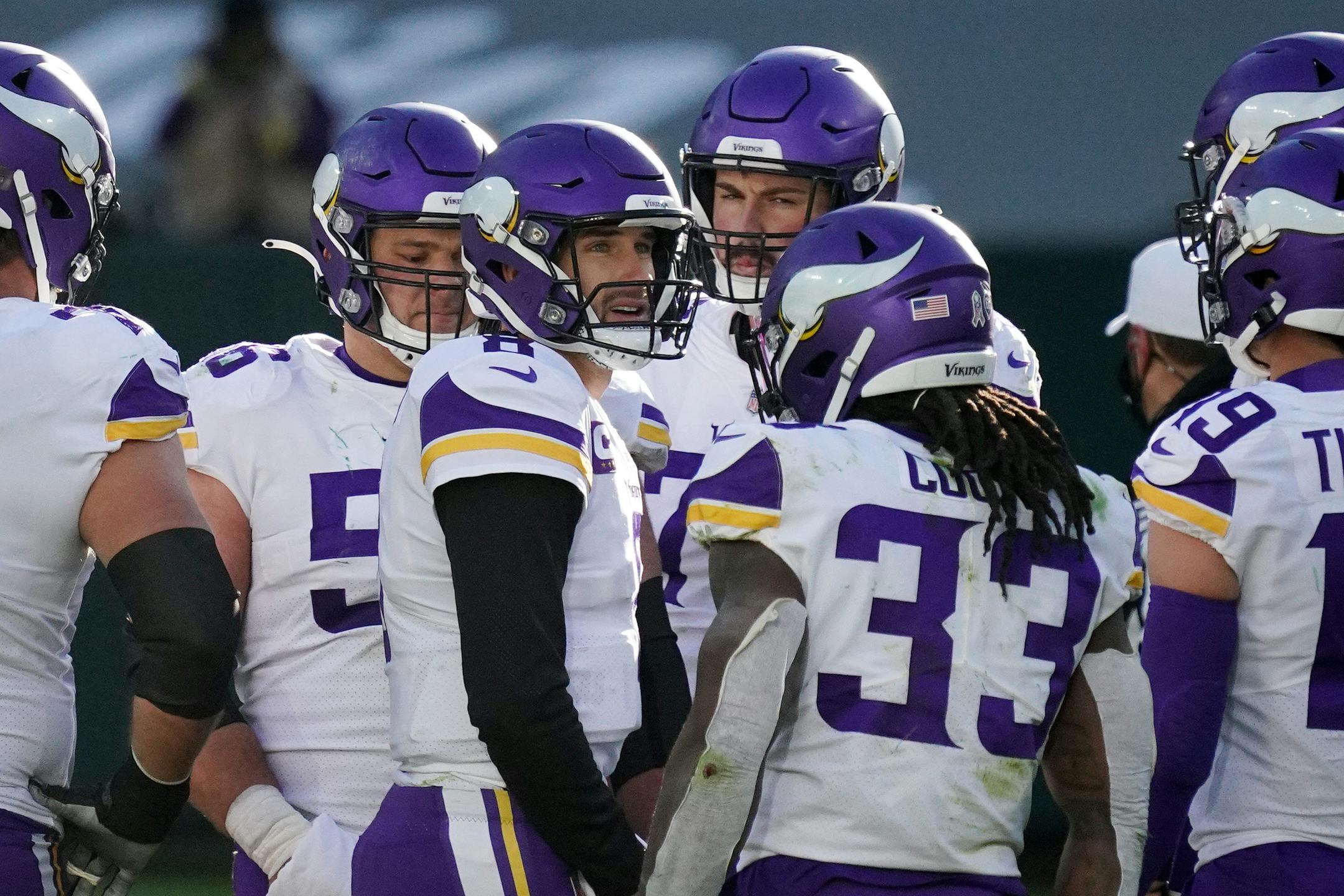 Vikings quarterback Kirk Cousins stood with teammates in the fourth quarter at Green Bay.