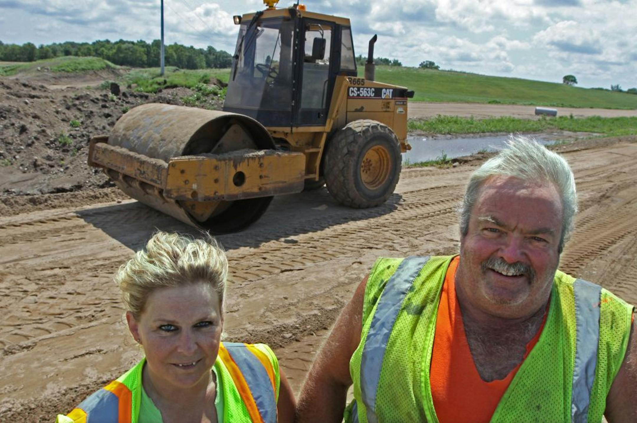 KGM Contractors and its workers will feel the sting of state shutdown for a long time. Roller driver Becky Radle and her husband, foreman Dan Radle, and daughter Kelsey (not pictured) were laid off during the shutdown. They're back building the Hwy. 23 bypass in Paynesville, Minn.