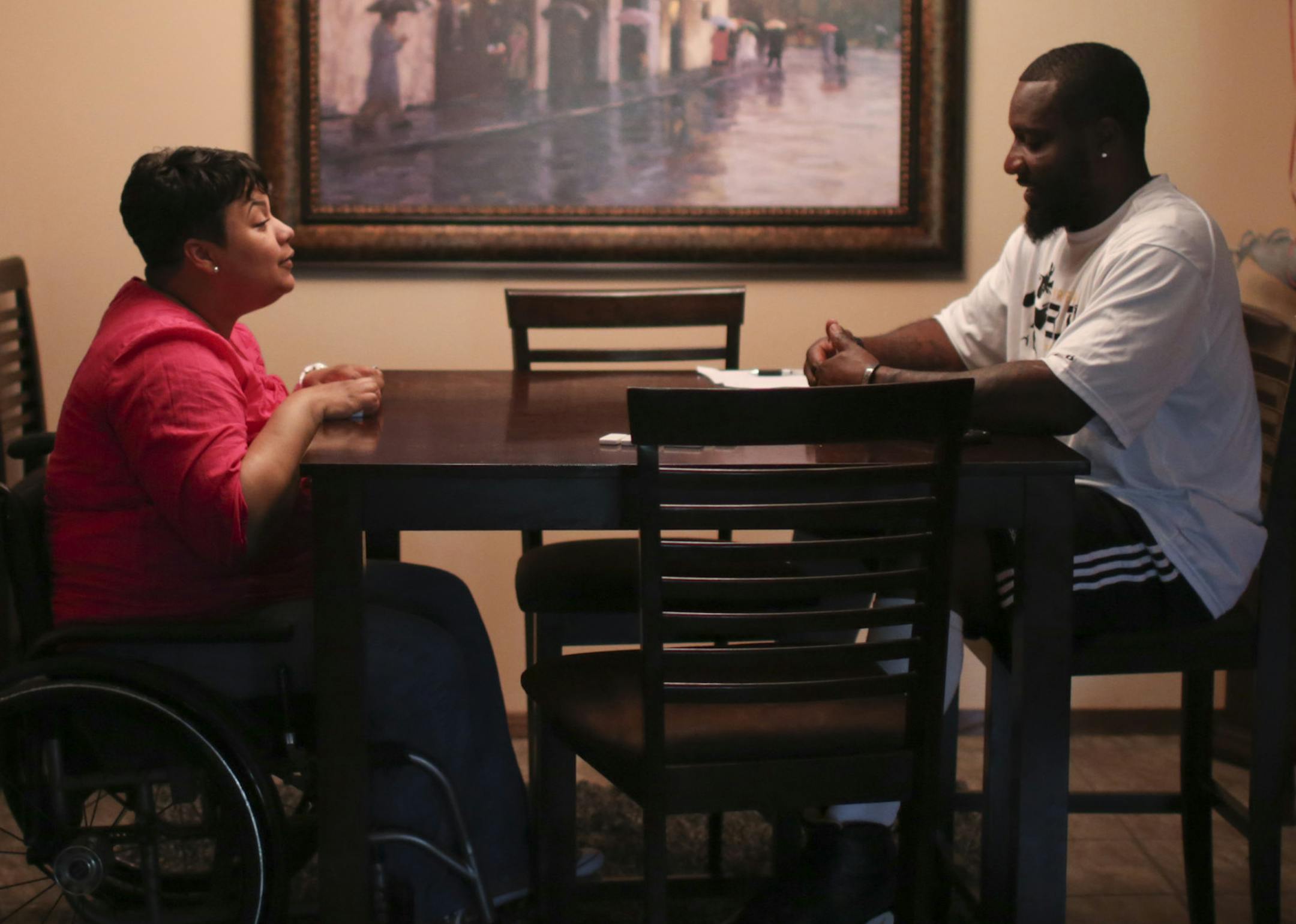 With their young son napping and their daughter our with her grandparents, April and Tyrone Carter relaxed with a game of dominos in their St. Louis Park home. ] JEFF WHEELER &#x201a;&#xc4;&#xa2; jeff.wheeler@startribune.com Former Gopher standout and NFL player Tyrone Carter has moved back to the Twin Cities to be closer to his wife April's family and to launch his own football training camp. They were photographed in their St. Louis Park home Wednesday, June 4, 2014.