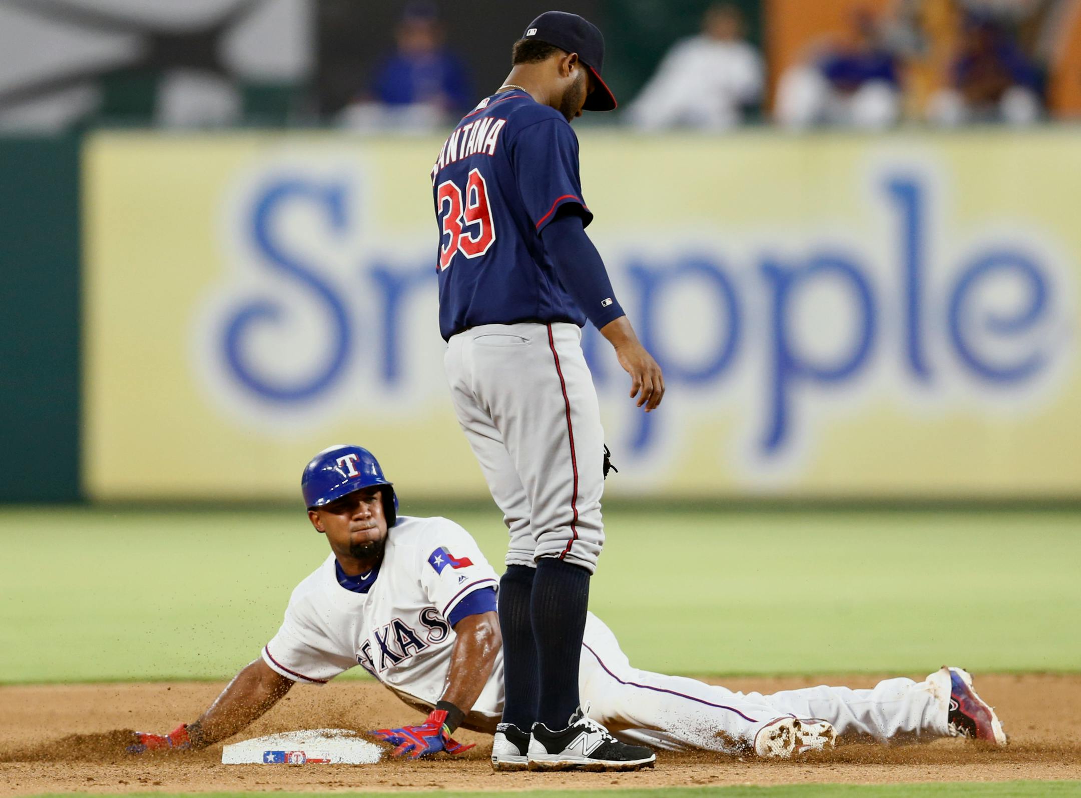Texas Rangers' Elvis Andrus steals second base in front of Minnesota Twins shortstop Danny Santana (39) during the fourth inning of a baseball game, Friday, July 8, 2016, in Arlington, Texas. (AP Photo/Jim Cowsert)