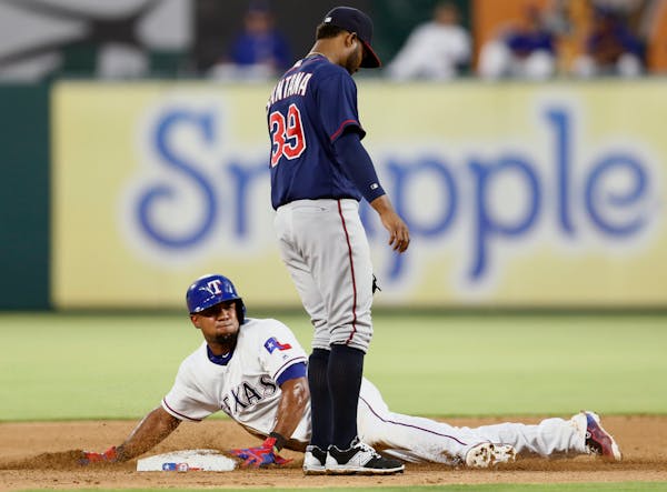 Texas Rangers' Elvis Andrus steals second base in front of Minnesota Twins shortstop Danny Santana (39) during the fourth inning of a baseball game, F