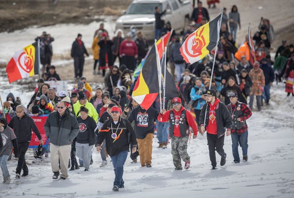 After a 7-mile trek, Native Americans merged and met at the Wounded Knee Memorial site South Dakota on Monday. Some walked, some rode horses and some 