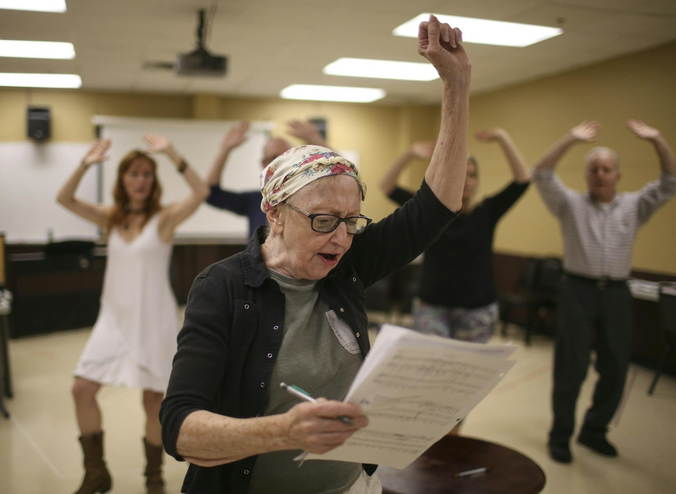 Sandra Struthers, Adam Qualls, Ruthie Baker, and Gary Briggle, rear, from left, danced while Wendy Lehr, foreground, playing a lawyer, sang, during rehearsal Wednesday night.