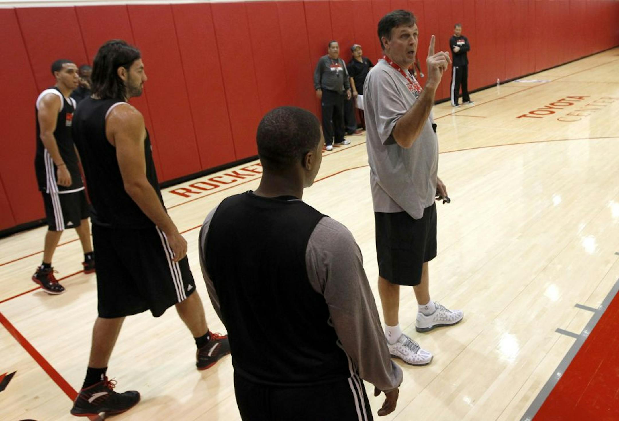 Houston Rockets coach Kevin McHale, right, instructs players during their first training camp workout of the 2011-2012 NBA basketball season on Friday, Dec. 9, 2011, in Houston.