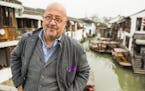ZHUJIAJIAO, CHINA - MARCH 20: Host Andrew Zimmern poses for a portrait on a bridge in the ancient water town of Zhujiajiao in China. As seen on Travel