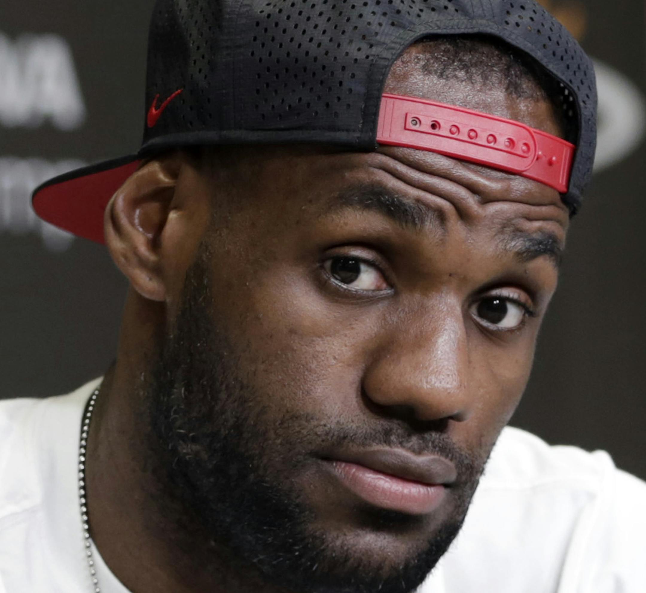 FILE - In this June 17, 2014 file photo, Miami Heat's LeBron James gestures as he answers a question during a news conference in Miami. LeBron James held meetings for more than three hours in a Las Vegas hotel Tuesday, July 8, 2014 leaving without giving any indication of what team heíll play for next season. (AP Photo/Alan Diaz, File)