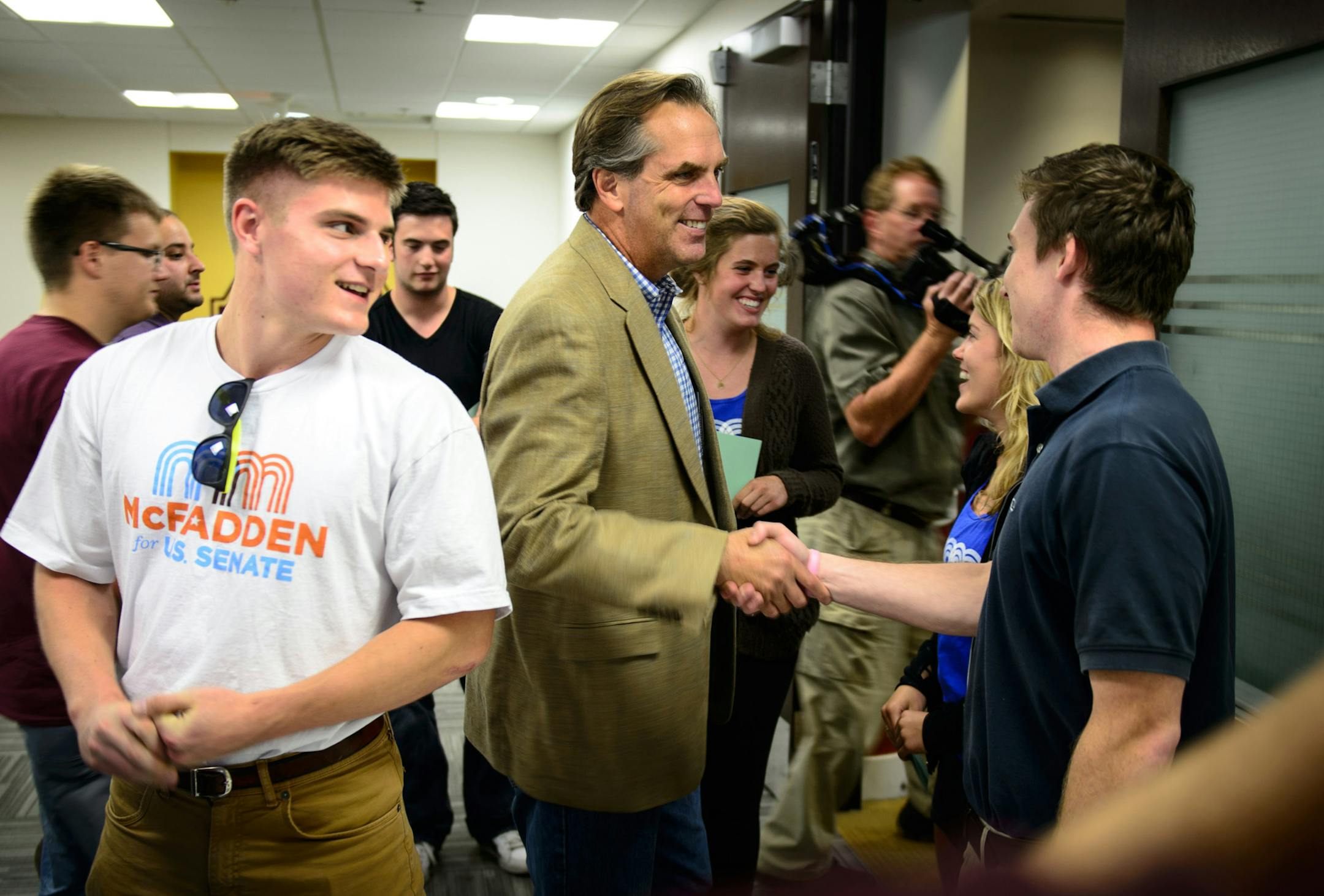 GOP candidate for U.S. Senate Mike McFadden greeted supporters and University of Minnesota students on his way into a town hall style Q &A Tuesday, September 23, 2014 at the Coffman Student Union at the University of Minnesota. His son Conor, left and daughter Molly, background right, came with him. ] GLEN STUBBE * gstubbe@startribune.com