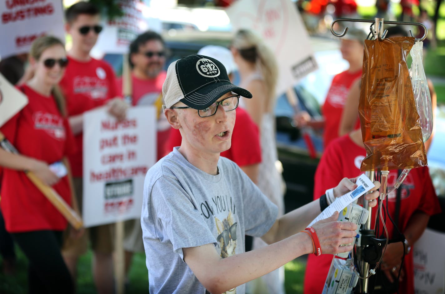 Joe Skubic 27, of Maple Grove has been a cancer patient at Abbott for past two years. On Sunday he came out of his hospital room to show support for his nurse. Thousands of nurses walked around Abbott Northwestern on the first day of the strike Sunday June 19, 2016 in Minneapolis, MN.] Day One in the Allina Health nurses strike. Jerry Holt /Jerry.Holt@Startribune.com