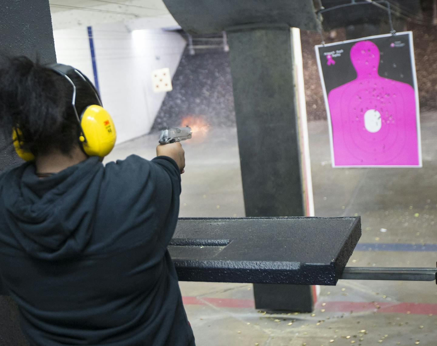 A woman practiced shooting a .45 caliber hand`gun at Bill's Gun Shop & Range in Robbinsdal.