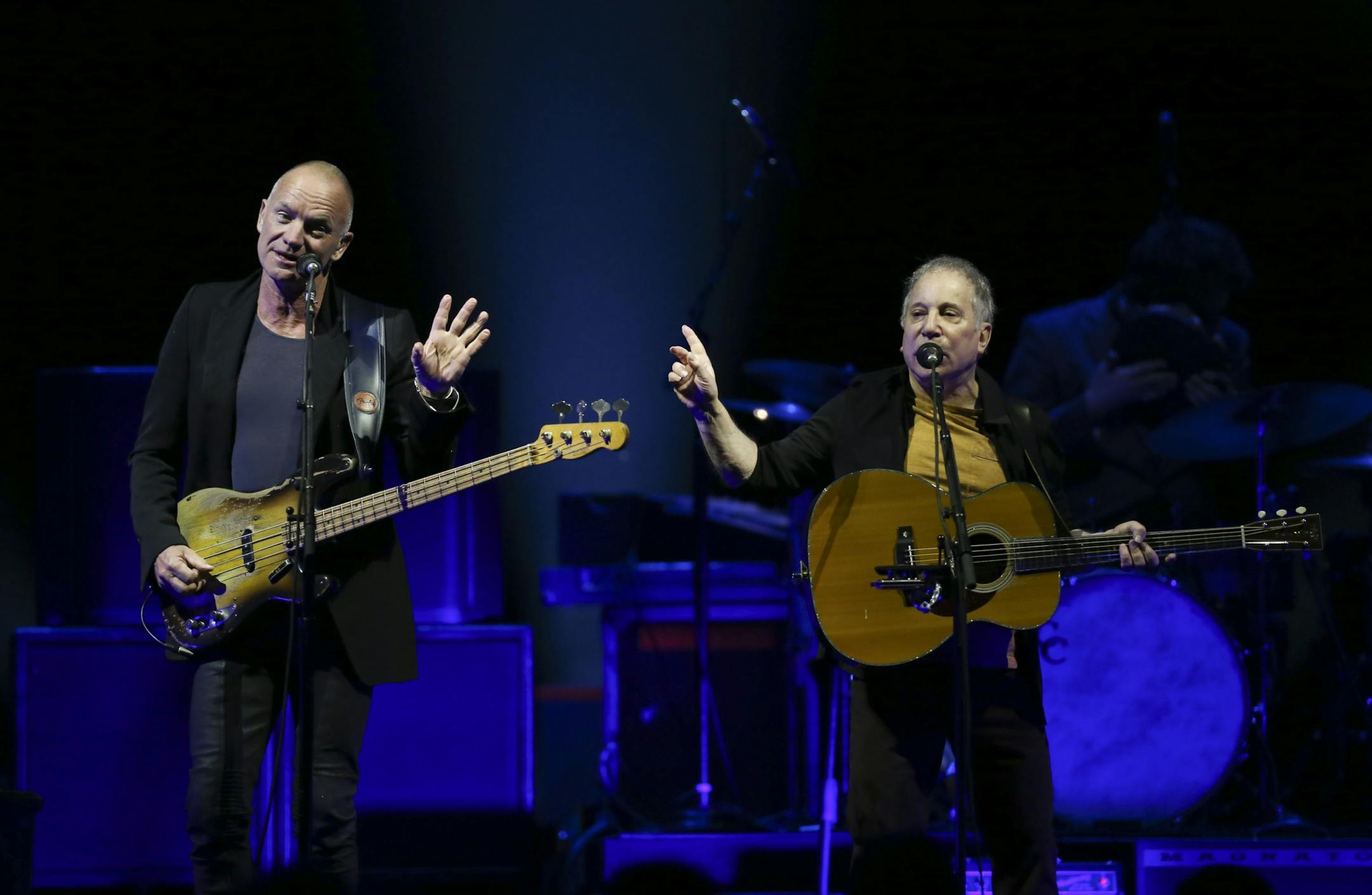 Longtime New York neighbors Sting and Paul Simon decided to hit the road and tour together. The Paul Simon & Sting: On Stage Together tour stopped at Xcel Energy Center in St. Paul Sunday night, February 23, 2014. Sting, left, and Paul Simon performing Sting's song "Brand New Day" to open their set Sunday night at Xcel Energy Center.
