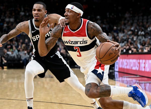 Washington Wizards' Bradley Beal (3) drives against San Antonio Spurs' Dejounte Murray during the first half of an NBA basketball game, Monday, Nov. 2