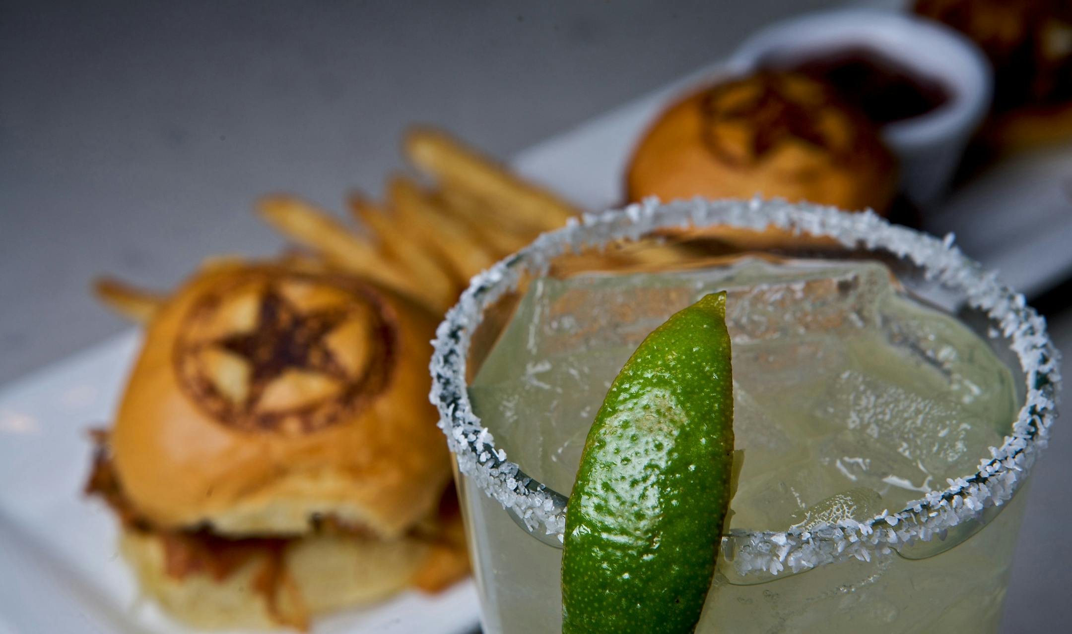 Two Laredo's highlights: A salty-rimmed margarita and a trio of slider-style pulled-pork sandwiches served with fries.