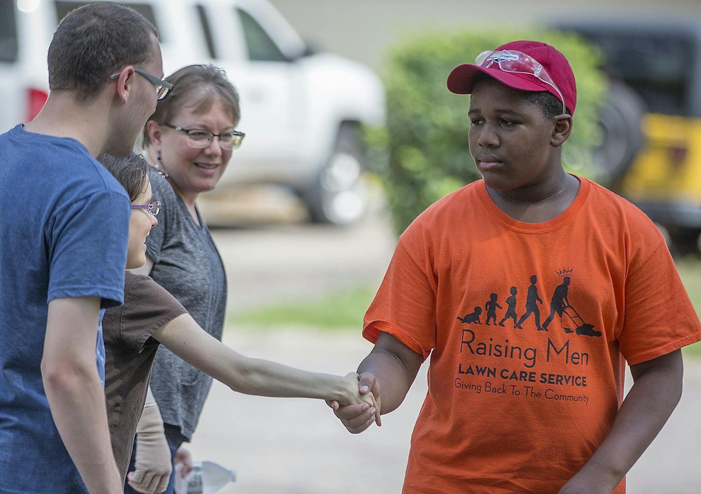 Twelve-year-old Tyquan Brown received water and a thank-you from the homeowners after he helped mow their lawn, Thursday, July 12, 2018 in Hopkins, MN. ] ELIZABETH FLORES &#xef; liz.flores@startribune.com