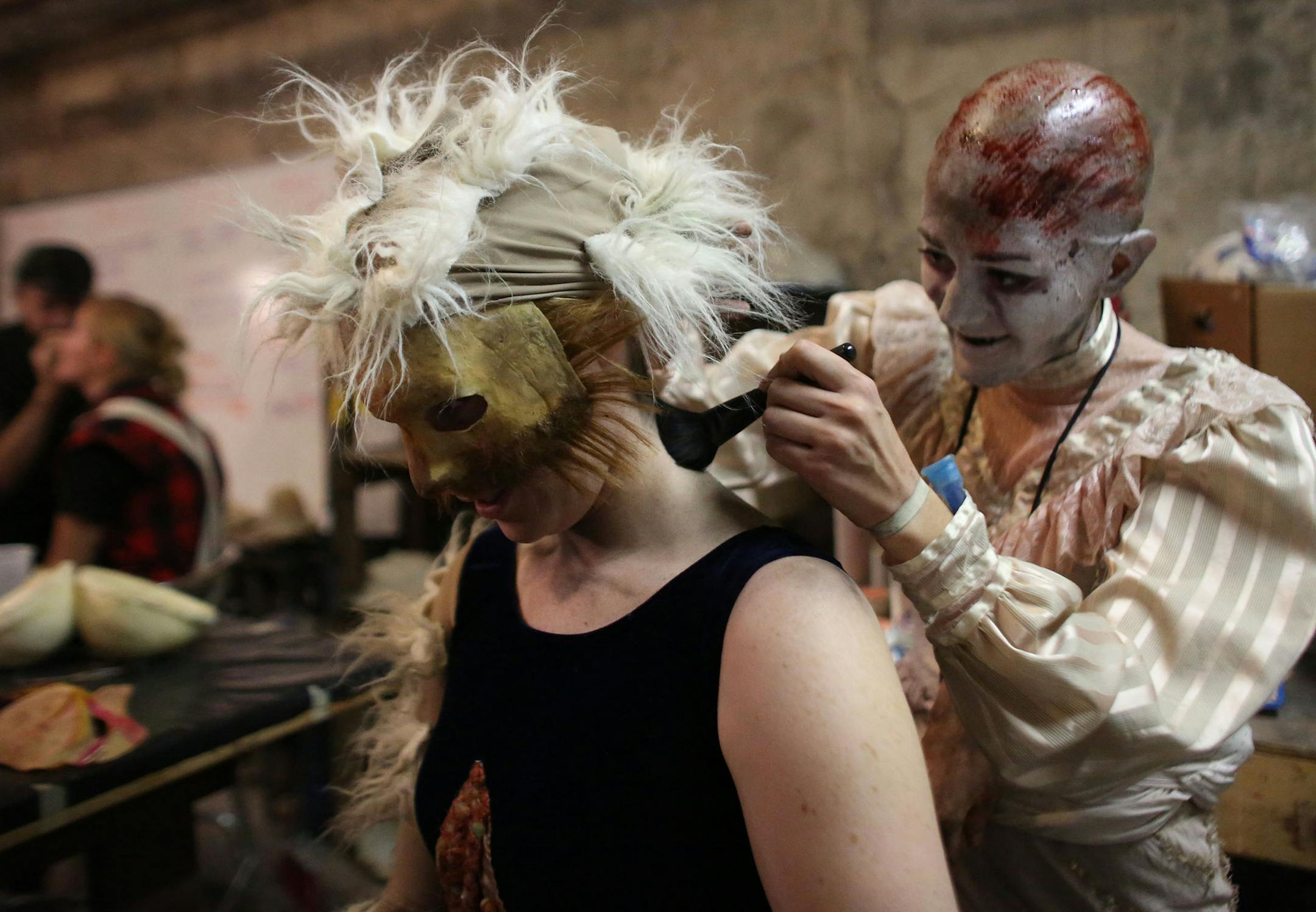 Actor Becca Hart helped Kali Western, with her makeup in the green room before patrons arrive to be scared. ] (KYNDELL HARKNESS/STAR TRIBUNE) kyndell.harkness@startribune.com Haunted Basement at the Soap Factory in Minneapolis Min., Wednesday, October 1, 2014.
