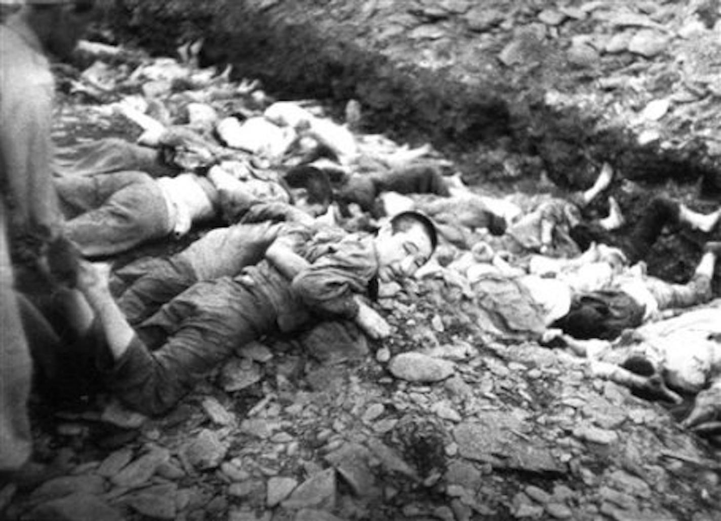 FILE - In this July 1950 U.S. Army file photograph once classified "top secret," prisoners lie on the ground before their execution by South Korean troops in Taejon, South Korea. Shutting down its inquiry into South Korea's hidden history, a government commission investigating a century of human rights abuses will leave unexplored scores of suspected mass graves believed to hold remains of tens of thousands of South Korean political detainees summarily executed by their government early in the Korean War, sometimes as U.S. officers watched. In a political about-face, the commission, which also investigated the U.S. military's large-scale killing of Korean War refugees, has ruled the Americans in case after case acted out of military necessity. (AP Photo/National Archives, Major Abbott/U.S. Army, File) NO SALES