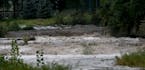 Water from torrential rains cascades over Cannon Falls on the Little Cannon River after big rainfalls Tuesday and early Wednesday, Sept. 5, 2018, in C