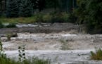 Water from torrential rains cascades over Cannon Falls on the Little Cannon River after big rainfalls Tuesday and early Wednesday, Sept. 5, 2018, in C