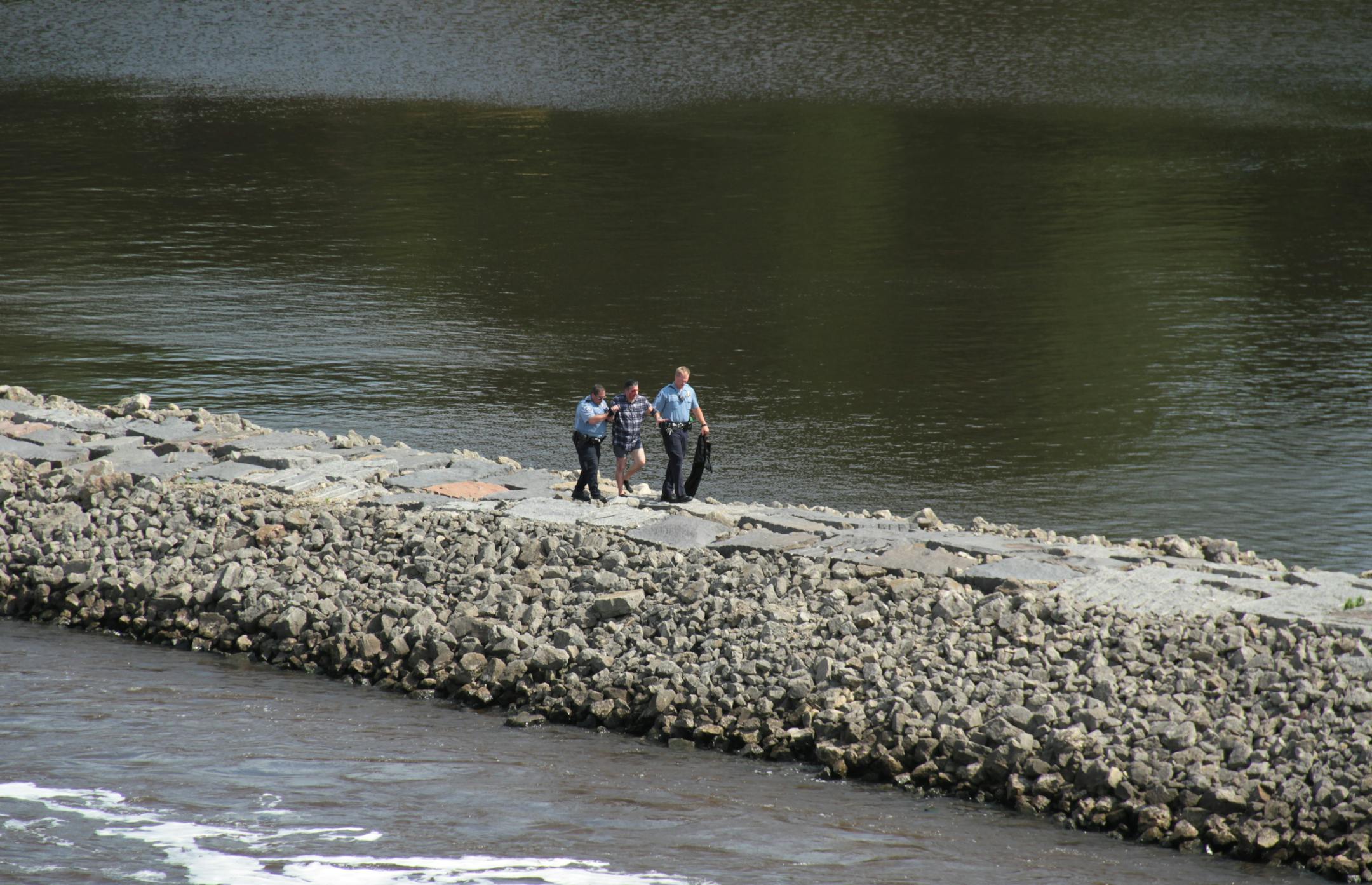 Officers helped a man out of the river below the Stone Arch Bridge Saturday afternoon.