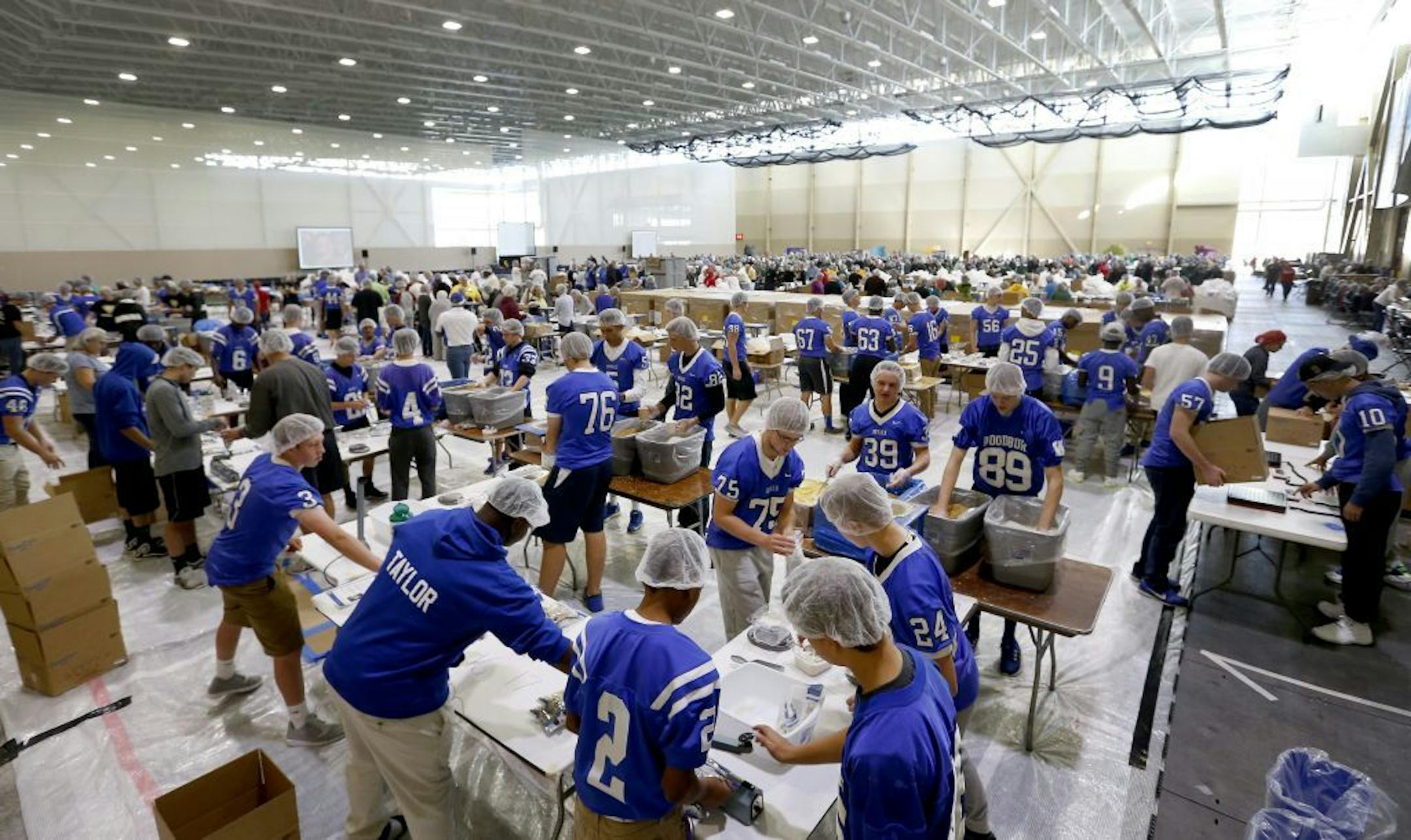 Volunteers packed meals for Feed My Starving Children at the Bielenberg Sports Center in Woodbury on Thursday.