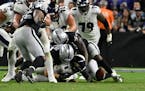 Las Vegas Raiders defensive end Carl Nassib (94) forces a fumble by Baltimore Ravens quarterback Lamar Jackson (8) during overtime in an NFL football 