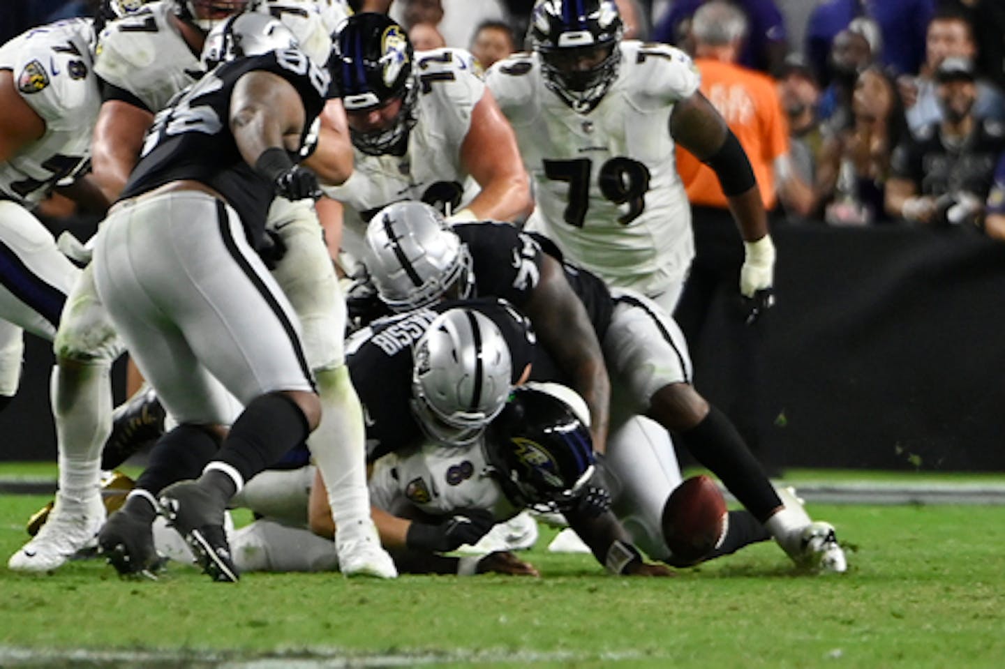 Las Vegas Raiders defensive end Carl Nassib (94) forces a fumble by Baltimore Ravens quarterback Lamar Jackson (8) during overtime in an NFL football game, Monday, Sept. 13, 2021, in Las Vegas. (AP Photo/David Becker)