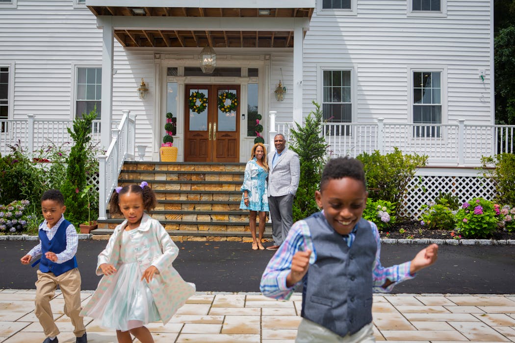Jamie and Frantz Arty with their children Fitzgerald and Fallon, 5, and Frantz, 7, in front of their home on Long Island.