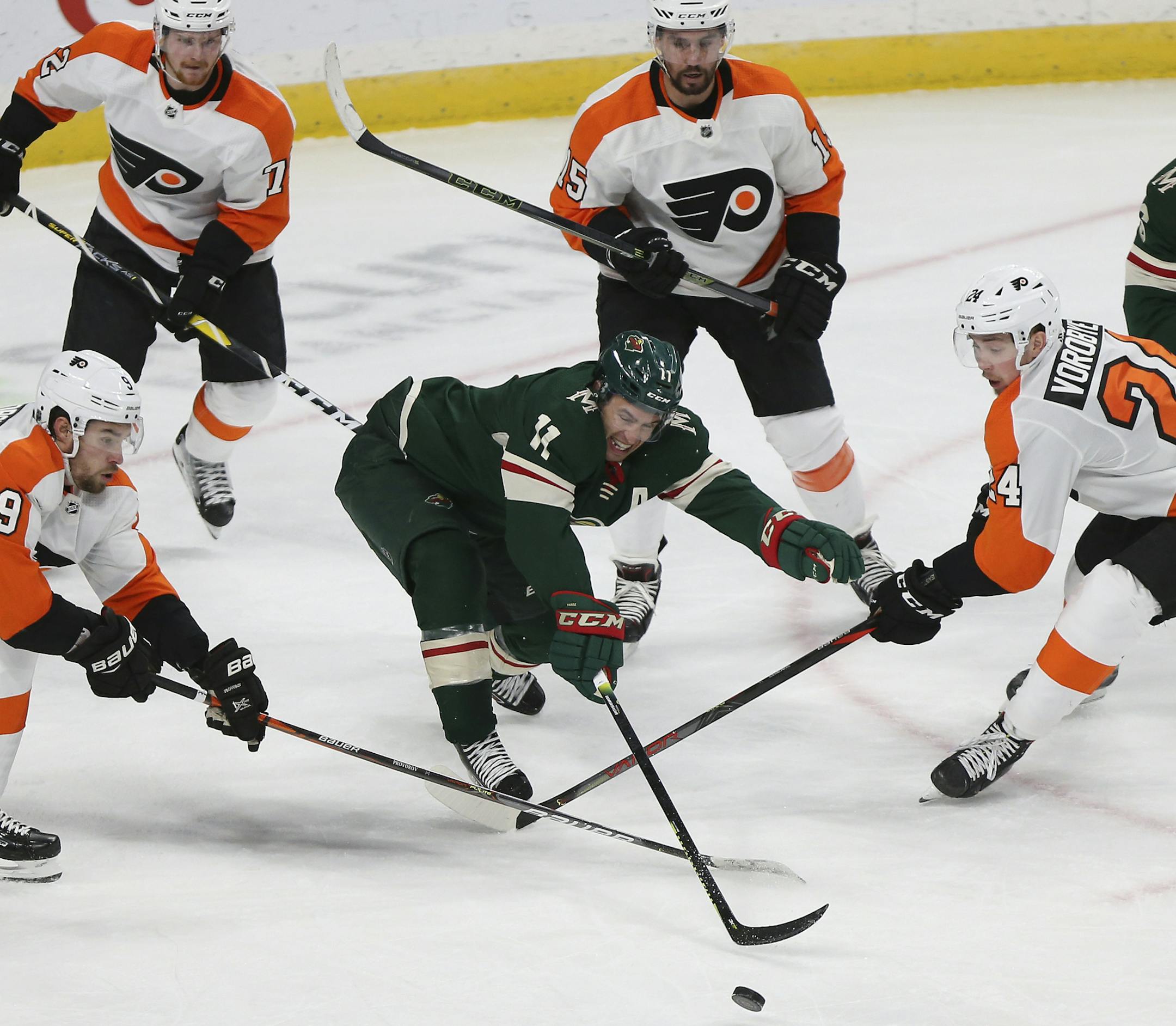 Minnesota Wild's Zach Parise goes after the puck against Philadelphia Flyers' Ivan Provorov of Russia, left, and Mikhail Vorobyev of Russia, right, in the third period of an NHL hockey game Saturday Dec. 14, 2019, in St. Paul, Minn. Minnesota won 4-1. (AP Photo/Stacy Bengs)