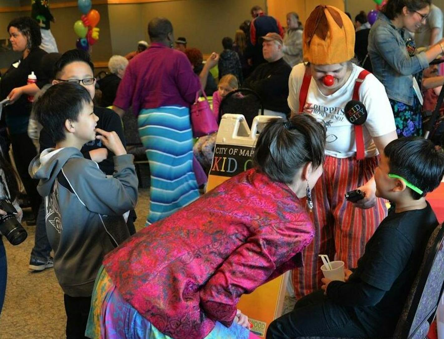 A clown with Z Puppets Rosenschnoz collects audio of laughter for the Kid City Laughter Museum at the 2016 Laugh-In event, held at the Maplewood YMCA.