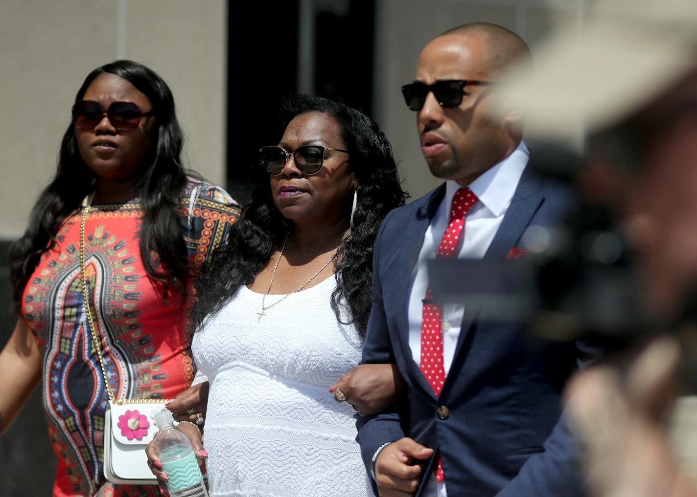 Valerie Castile, Philando's mother, center, is escorted to the courtroom by Charles Johnson of the Hatchett Firm, right, and Allysza Castile, Philando's sister, Thursday, June 15, 2017, in St. Paul, MN.