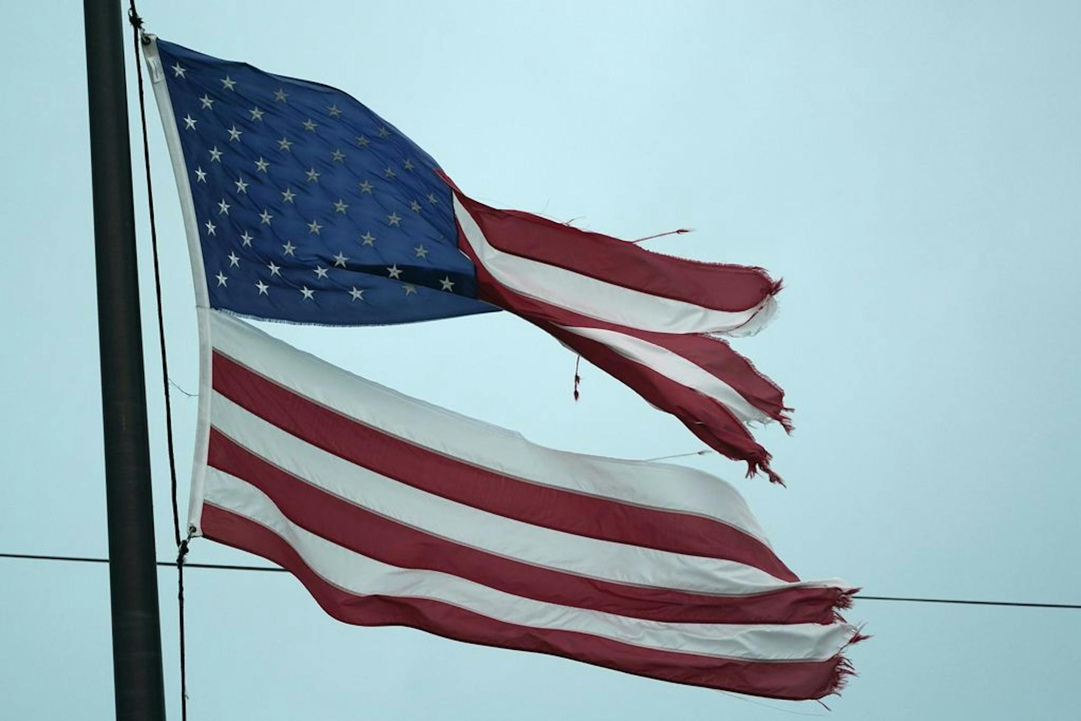 An U.S. flag damaged by high winds flies in Layton, Fla., in the Florida Keys, Monday, Nov. 9, 2020. Tropical Storm Eta had top sustained winds of 65 mph Sunday night as it crossed over the Florida Keys.