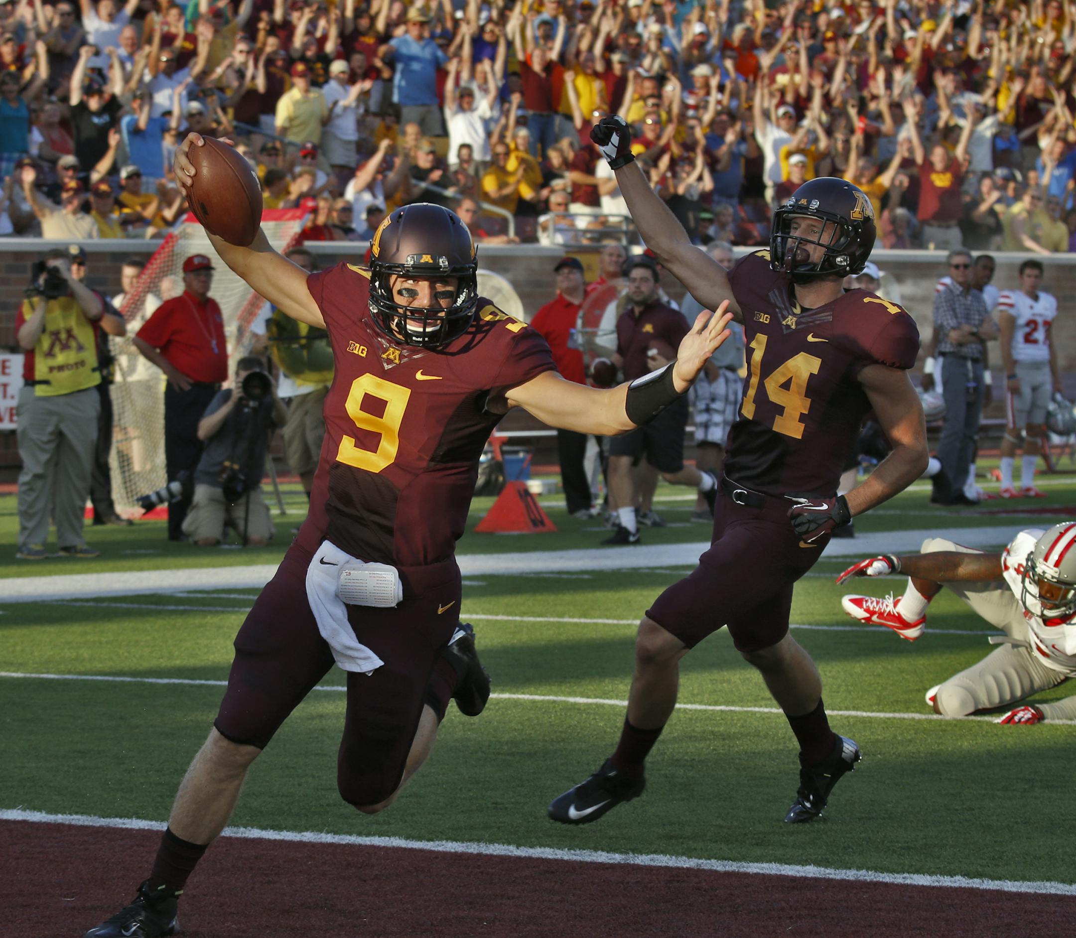 Minnesota Gophers vs. UNLV. Gophers quarterback Philip Nelson (9) celebrated his 48-yard touchdown run, the longest of his career, in first half action.