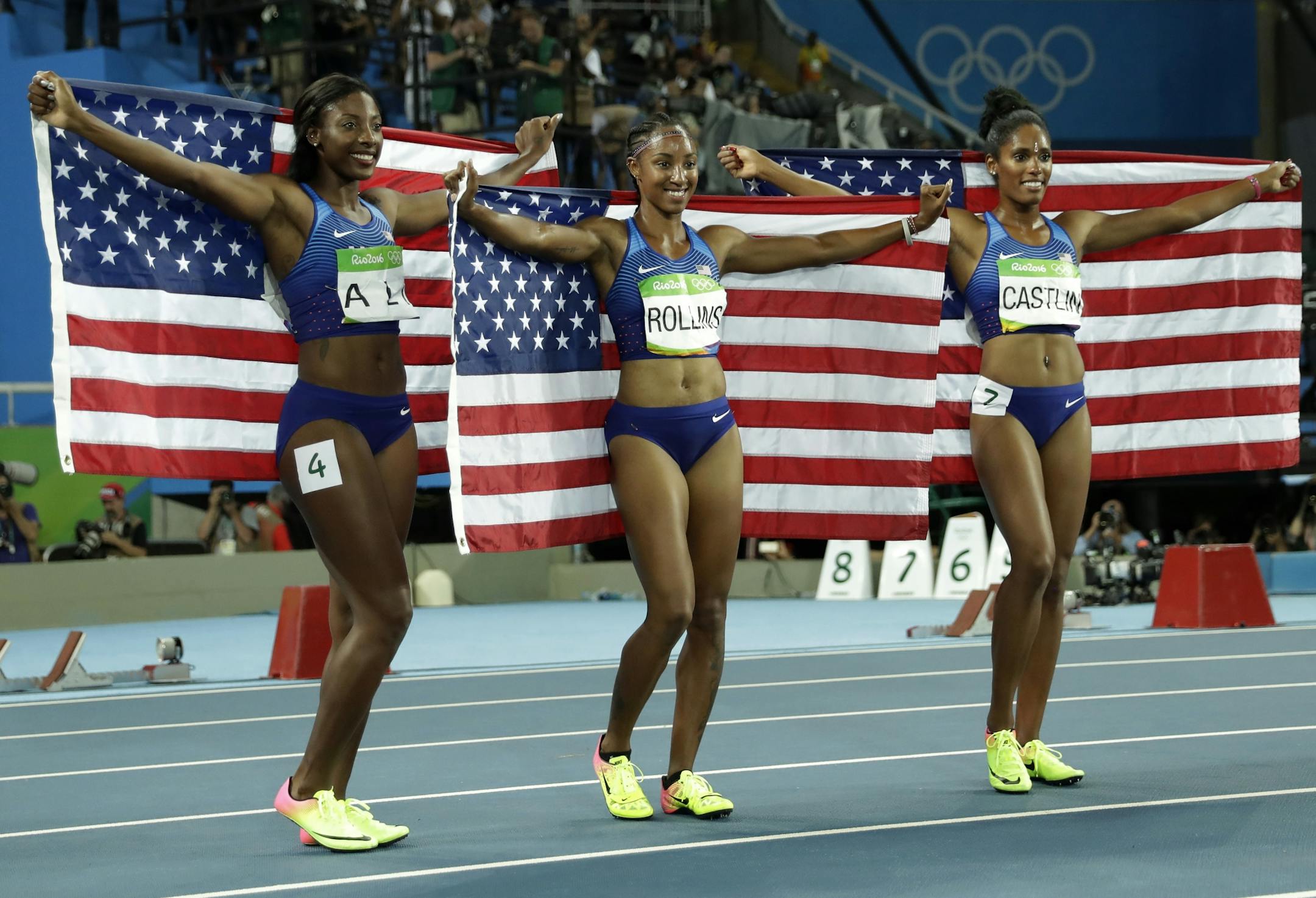 Gold medal winner Brianna Rollins, silver medal winner, Nia Ali and bronze medal winner Kristi Castlin, all from the United States, pose with their country's flag after the 100-meter hurdles final, during the athletics competitions of the 2016 Summer Olympics at the Olympic stadium in Rio de Janeiro, Brazil, Wednesday, Aug. 17, 2016.