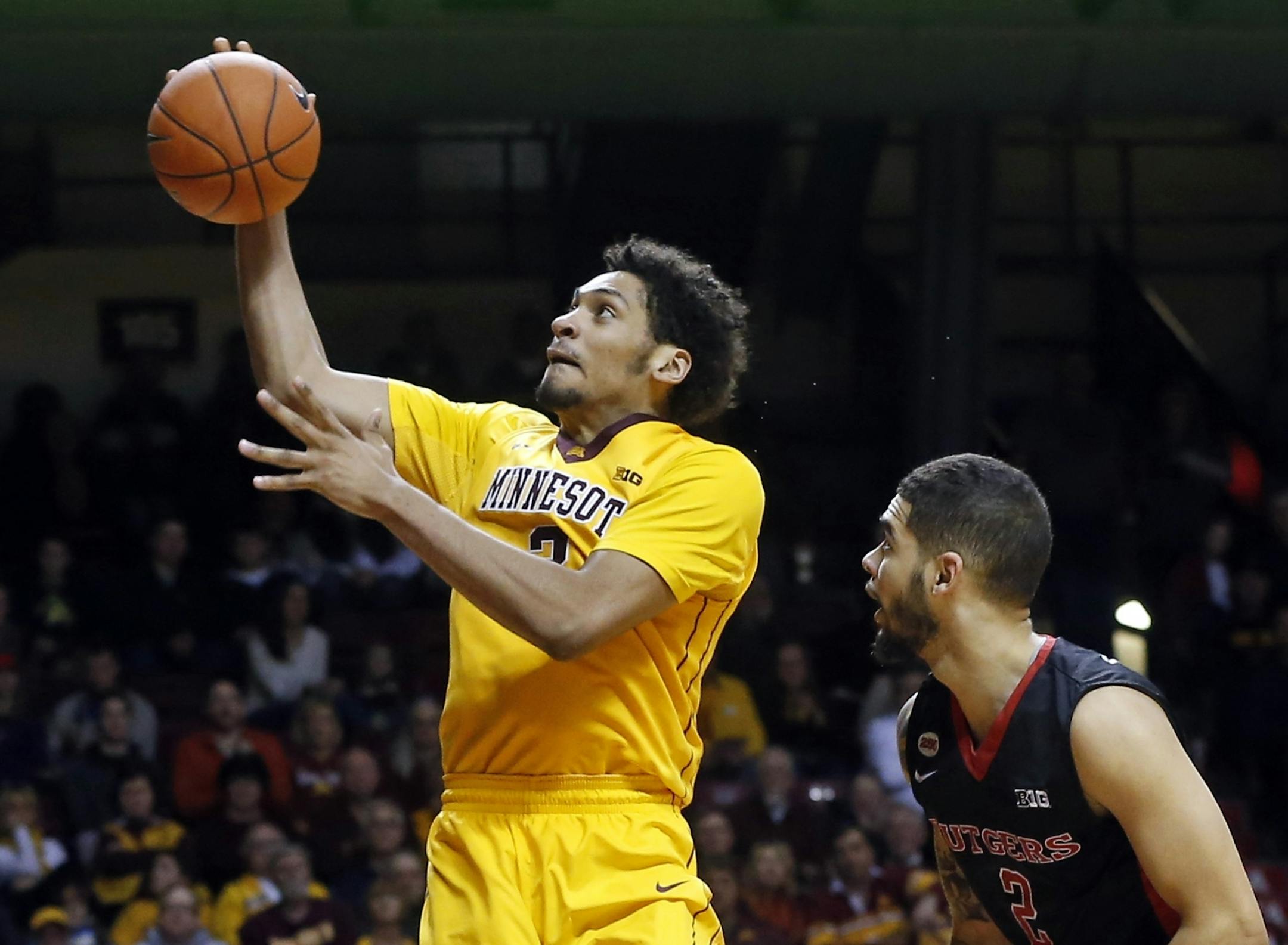 Minnesota's Jordan Murphy, left, eyes the basket as Rutgers' D.J. Foreman watches during the second half of an NCAA college basketball game Tuesday, Feb. 23, 2016, in Minneapolis. Minnesota won 83-61.