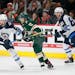 The Wild's Zach Parise (11) is double teamed by Winnipeg's Toby Enstrom (39) and Kyle Connor (81)