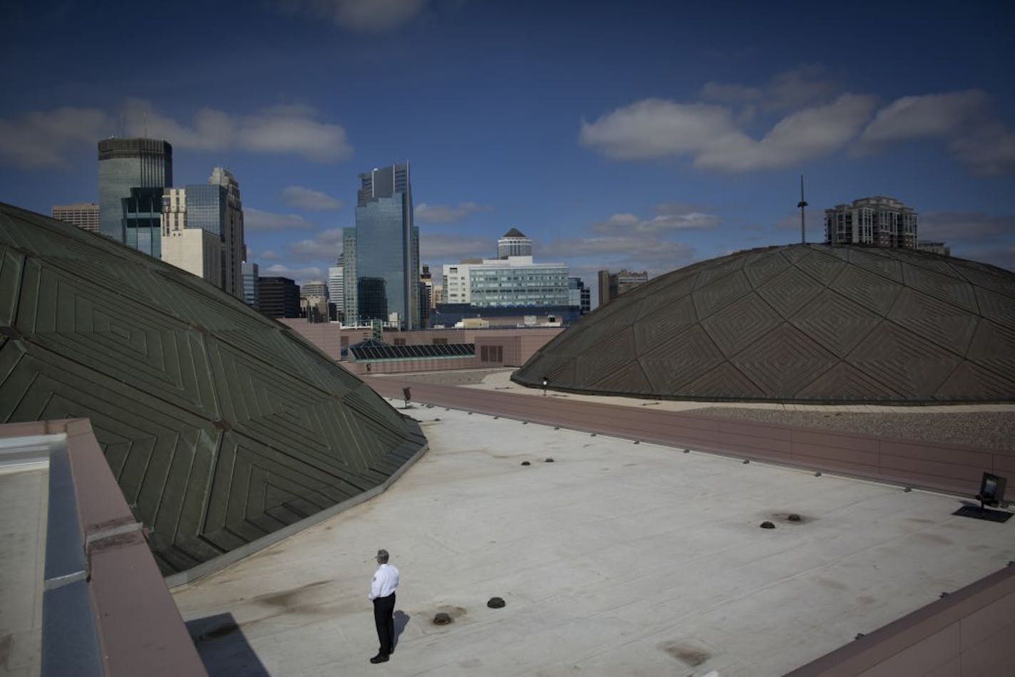 One of the original domes, left, and the newer dome, right, framed security guard Robert Nicpan and some of the Minneapolis skyline.