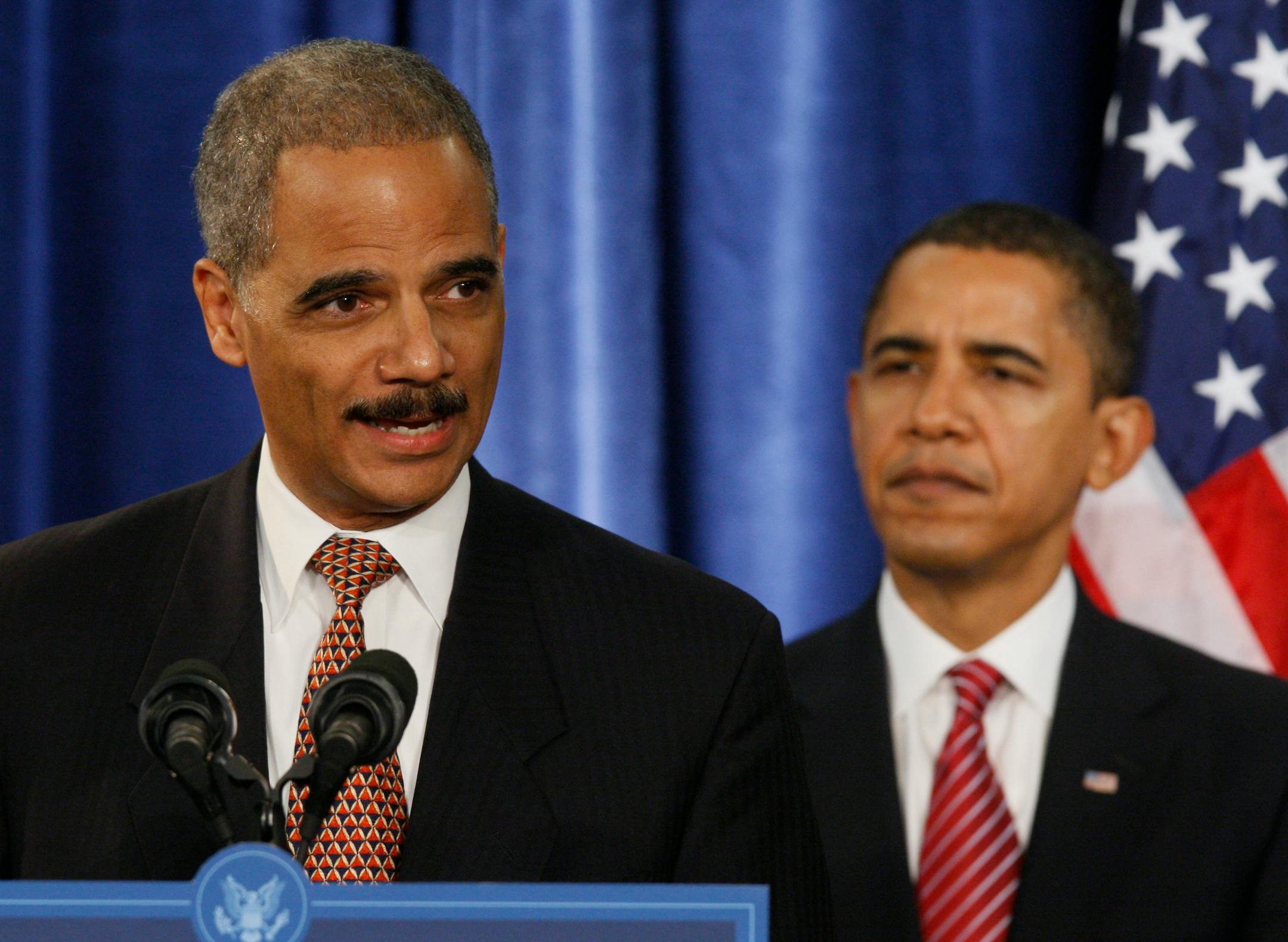 In this Dec. 1, 2008, file photo, Attorney General-designate Eric Holder speaks during a news conference with President-elect Barack Obama, right, in Chicago. Holder said his partnership at the law firm of Covington & Burling earned him $2.1 million this year.