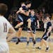 North Woods' Cade Goggleye (3) jumps into the arms of teammate Trevor Morrison after hitting a three-point shot with under a second left to lift North