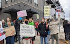 Housing advocates protested the decision to turn apartments into hotel space at Lincoln Park Flats in Duluth in April.