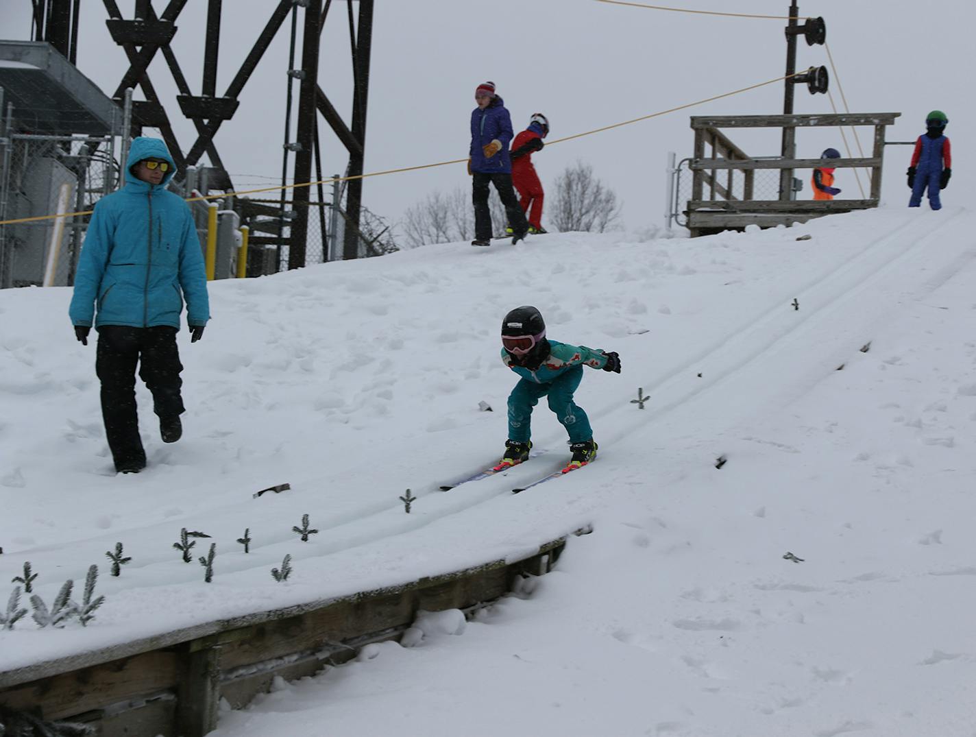 A young jumper headed down Wakefield Hill on the 10-meter jump at a "Learn to Jump Camp" day at St. Paul Ski Club.