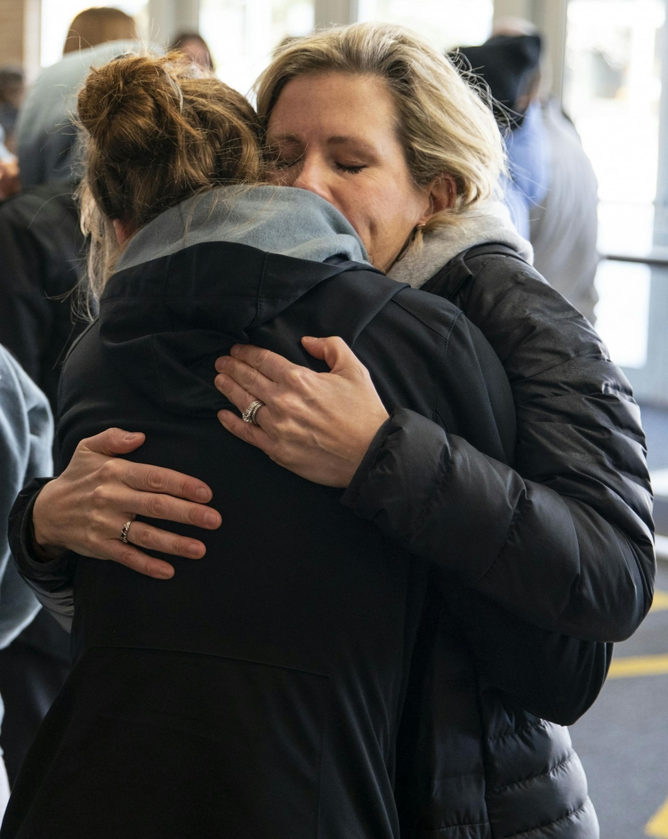 Duluth Marshall girl's basketball guard Merlea Mrozik was embraced by her mother, Leah, after returning to school Friday afternoon following the cancelation of the MSHL girl's basketball tournament.