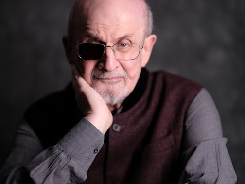 photo of author Salman Rushdie, in a gray shirt against a gray backdrop