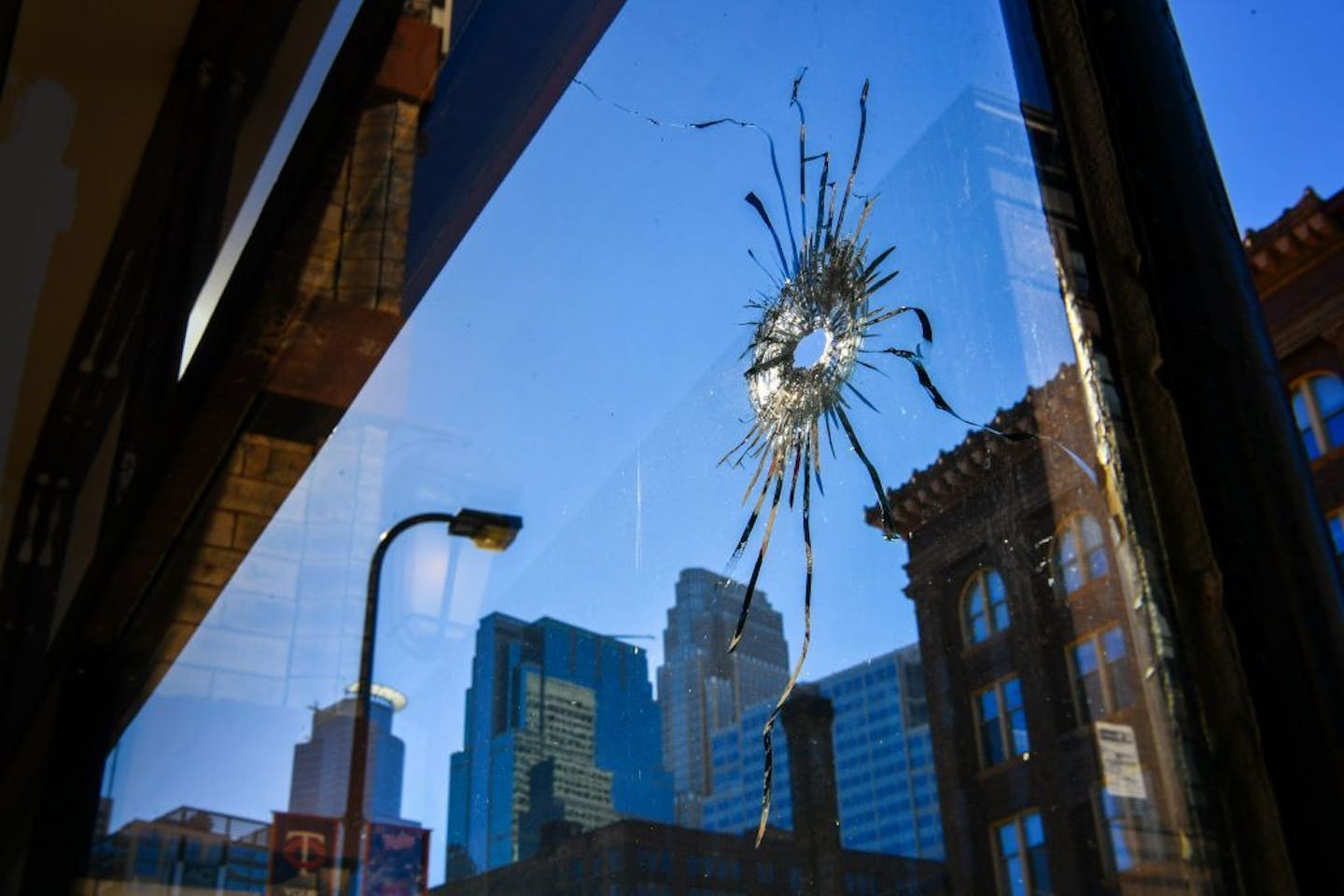 Two bullet holes in the glass of Jumpwings Heritage Brands Clothing store at 28 N 4th St right across the street from a police station.