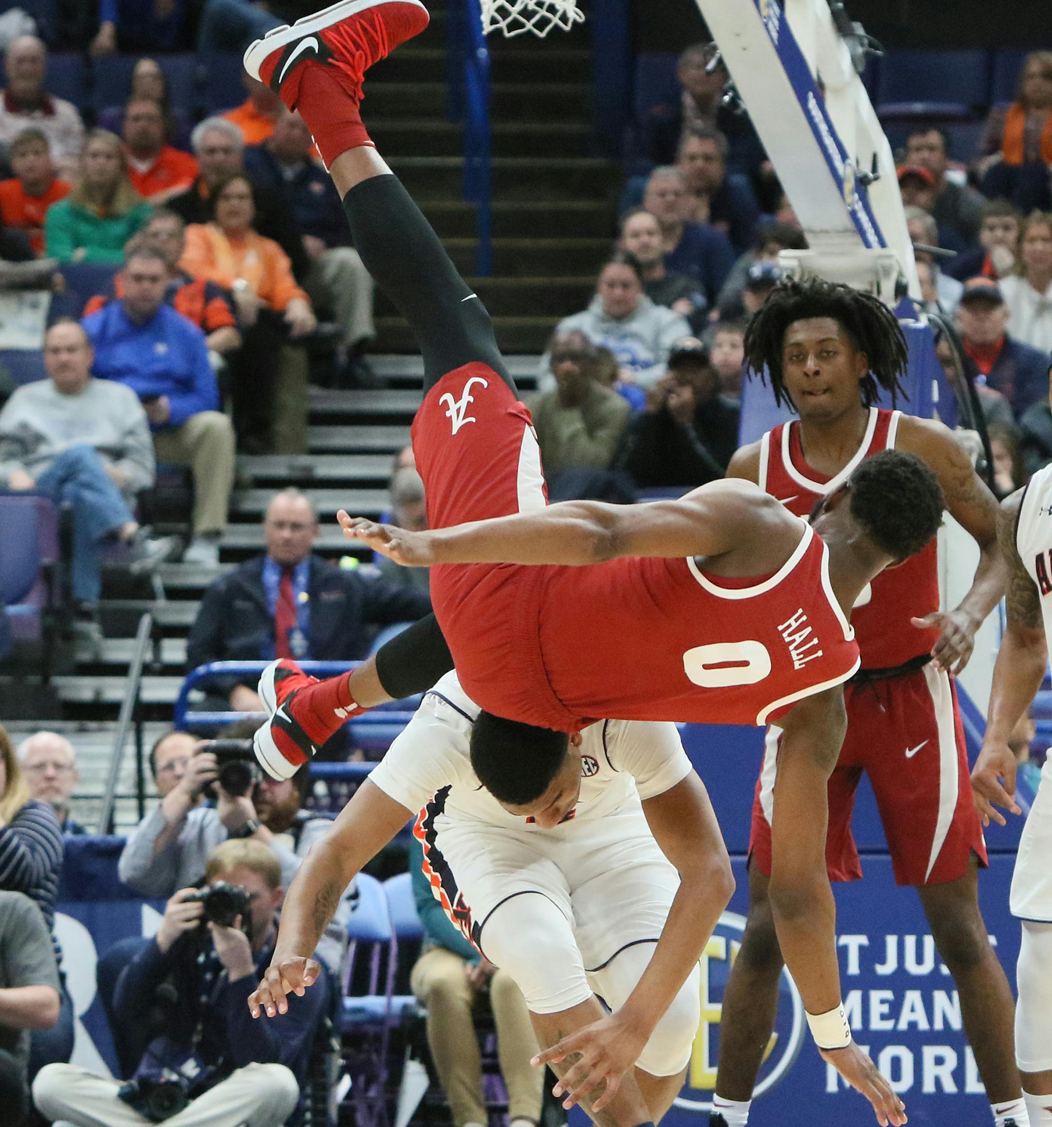 Alabama forward Donta Hall (0) tumbles over the back of Auburn forward Chuma Okeke in the second half during an SEC tournament quarterfinal game between Auburn and Alabama on Friday, March 9, 2018, at the Scottrade Center in St. Louis, Mo. (Chris Lee/St. Louis Post-Dispatch/TNS)