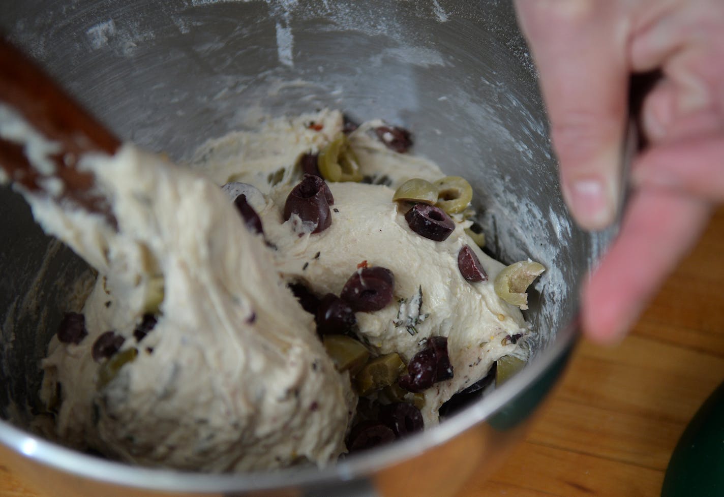 Gently fold the olives in with dough. ] (SPECIAL TO THE STAR TRIBUNE/BRE McGEE)