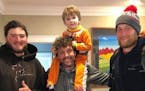 Dimitri Olympidis, with his son Niko, in his Valparaiso, Ind., home in April with Trevor Stephens, left, and Matt Andersen.