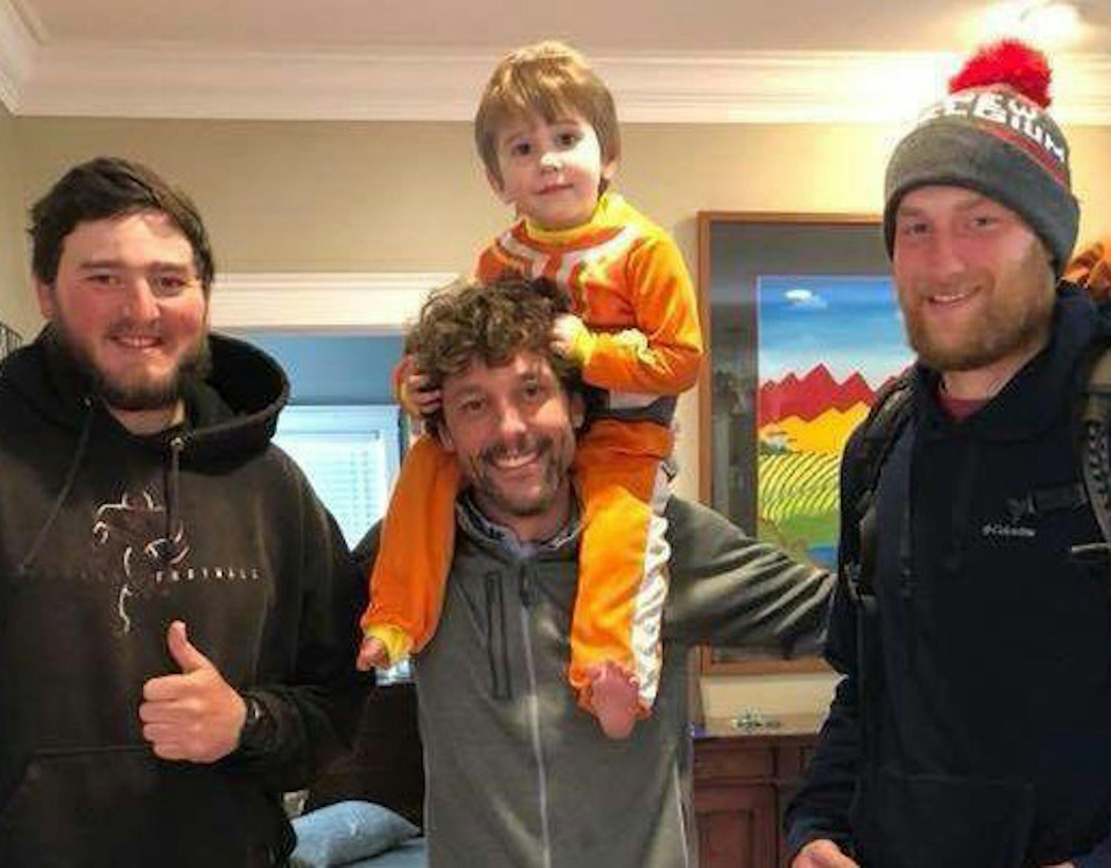 Dimitri Olympidis, with his son Niko, in his Valparaiso, Ind., home in April with Trevor Stephens, left, and Matt Andersen.